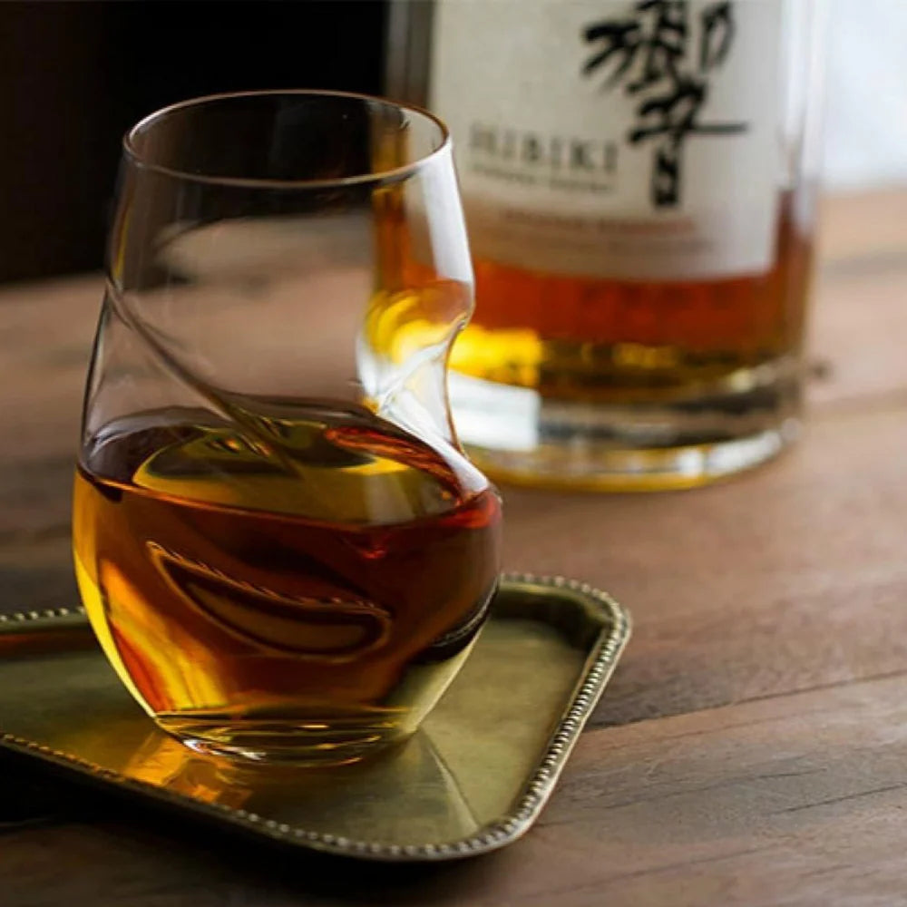Borosilicate whiskey glass reflecting light in twisted pattern