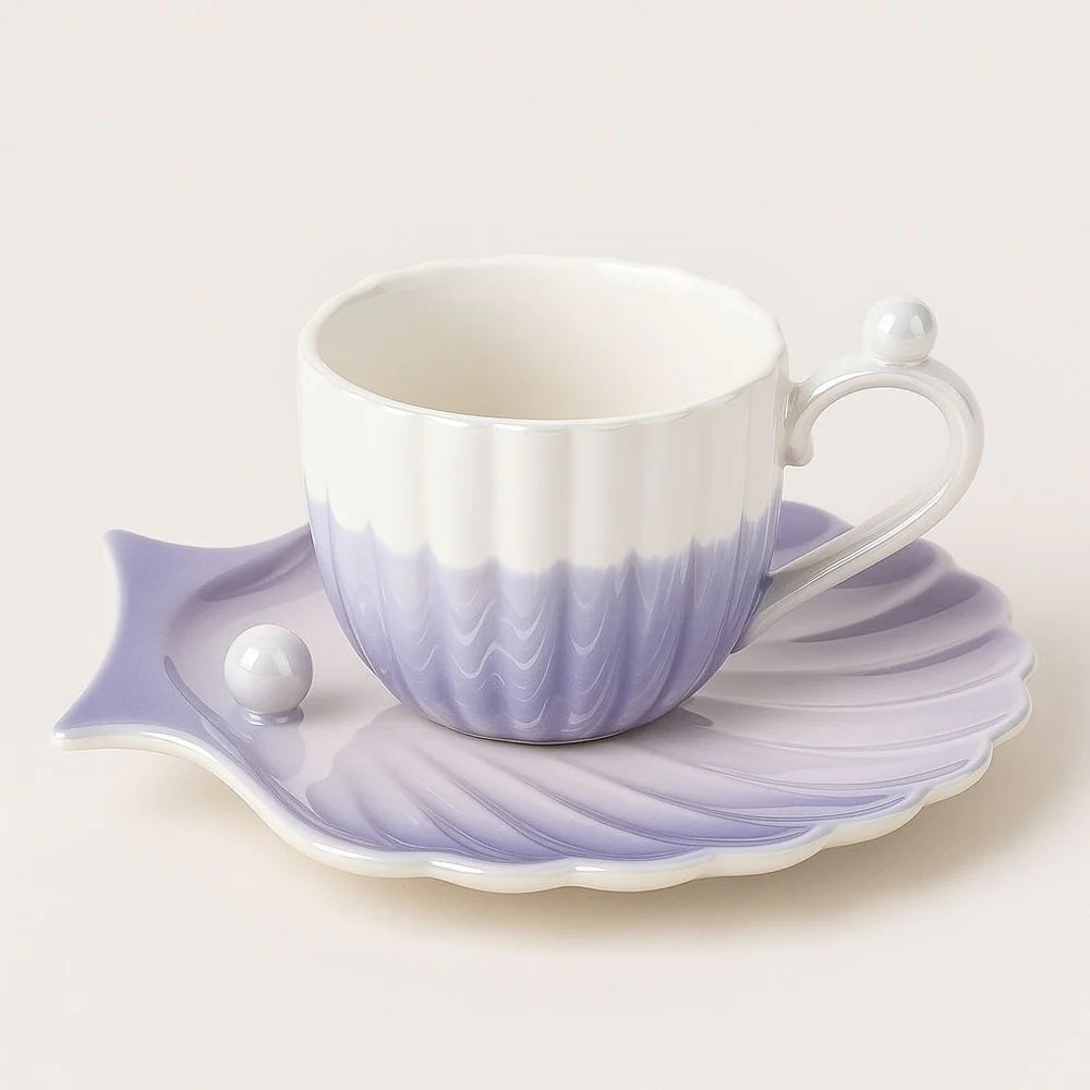 Fluted ceramic coffee cup with shell-shaped saucer